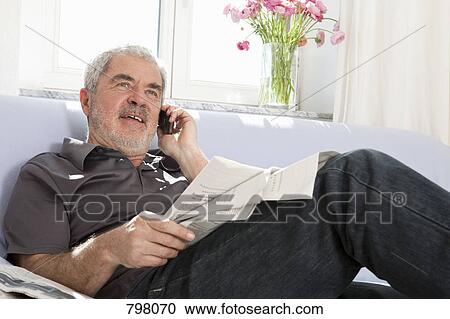 A senior man talking on a mobile phone View Large Photo Image Stock Image - A senior man talking on a mobile phone. Fotosearch