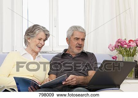 A senior woman and senior man using a laptop View Large Photo Image Stock Photo - A senior woman and senior man using a laptop. Fotosearch