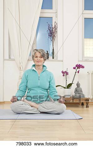 Stock Image - A senior woman doing yoga. Fotosearch