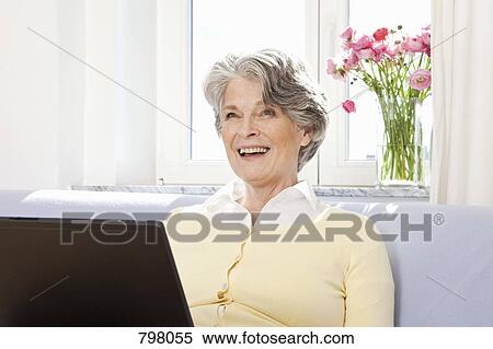 Stock Photography - A senior woman using a laptop. Fotosearch