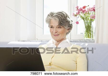 Stock Image - A woman using a laptop. Fotosearch