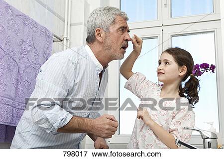 Stock Photo - A young girl and her grandfather. Fotosearch