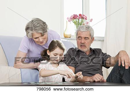 Stock Photograph - Grandparents and their granddaughter. Fotosearch