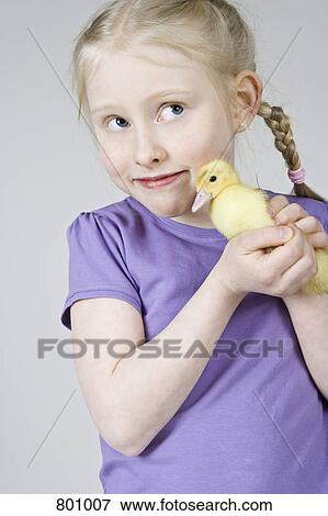 A girl holding a duckling View Large Photo Image Stock Photo - A girl holding a duckling. Fotosearch