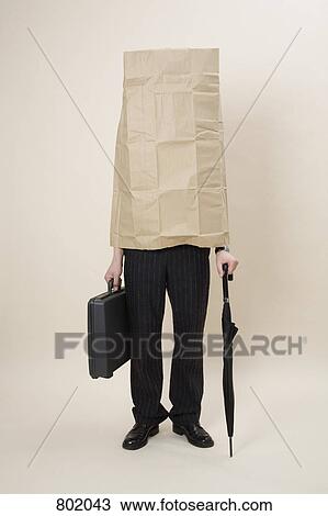 A businessman wearing a large paper bag View Large Photo Image Stock Image - A businessman wearing a large paper bag. Fotosearch