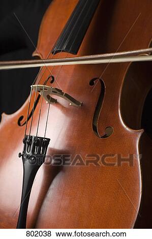 A cello with a bow being drawn across it View Large Photo Image Stock Photo - A cello with a bow being drawn across it. Fotosearch