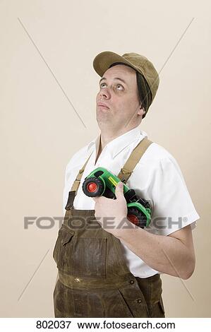 A farmer carrying a toy tractor View Large Photo Image Stock Photo - A farmer carrying a toy tractor. Fotosearch