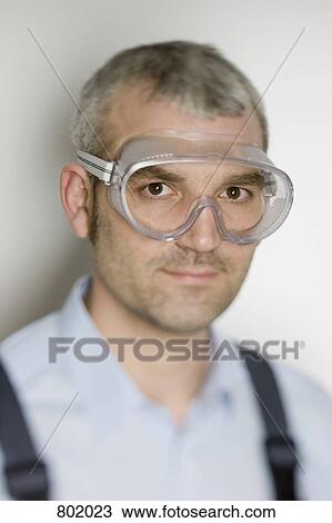 A man wearing protective eyewear View Large Photo Image Stock Image - A man wearing protective eyewear. Fotosearch