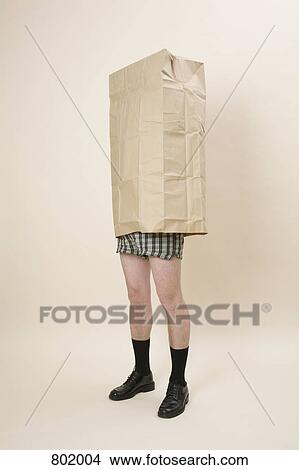 A semi-dressed man wearing a large paper bag View Large Photo Image Picture - A semi-dressed man wearing a large paper bag. Fotosearch