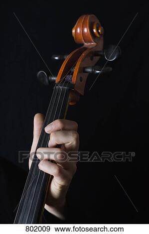 Human hand playing a cello View Large Photo Image Stock Photo - Human hand playing a cello. Fotosearch