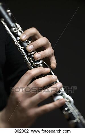 Human hands playing a clarinet View Large Photo Image Stock Image - Human hands playing a clarinet. Fotosearch