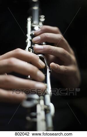 Human hands playing a clarinet View Large Photo Image Stock Image - Human hands playing a clarinet. Fotosearch