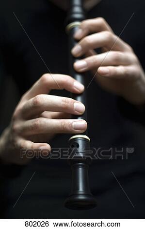 Stock Photograph - Human hands playing a recorder. Fotosearch