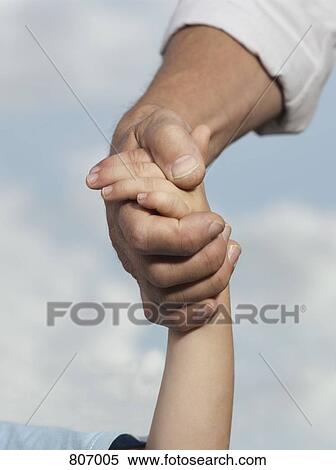 Detail of a child and a man holding hands View Large Photo Image Stock Photography - Detail of a child and a man holding hands. Fotosearch