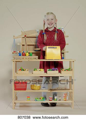 Portrait of a girl in a toy grocery store View Large Photo Image Stock Photo - Portrait of a girl in a toy grocery store. Fotosearch