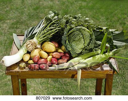 Selection of fresh vegetables on a wooden table View Large Photo Image Stock Photo - Selection of fresh vegetables on a wooden table. Fotosearch