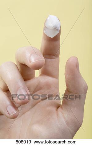 Stock Photo - A human finger with lotion on it. Fotosearch