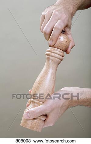Two human hands using a pepper mill View Large Photo Image Stock Photo - Two human hands using a pepper mill. Fotosearch