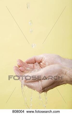 Picture - Water running into cupped hands. Fotosearch