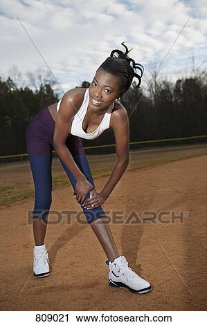 A woman stretching on a sports field View Large Photo Image Stock Image - A woman stretching on a sports field. Fotosearch