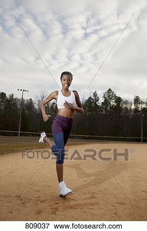 A woman warming up on a sports field View Large Photo Image Stock Photo - A woman warming up on a sports field. Fotosearch