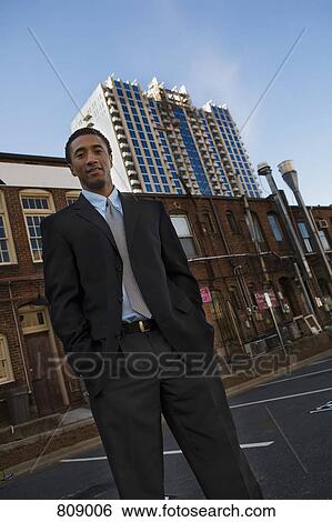 Businessman standing in the street View Large Photo Image Stock Photograph - Businessman standing in the street. Fotosearch