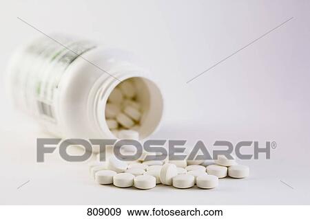 Stock Photo - Pills and a pill bottle. Fotosearch