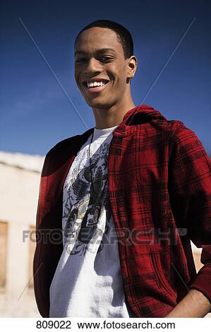 Stock Image - Portrait of a young man smiling. Fotosearch