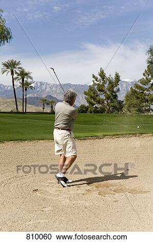 A golfer playing from a sand bunker, Palm Springs, California, USA View Large Photo Image Stock Image - A golfer playing from a sand bunker, Palm Springs, California, USA. Fotosearch