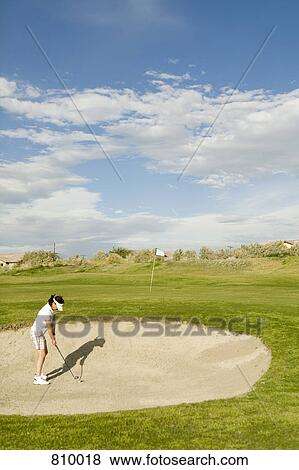 A golfer playing from a sand bunker View Large Photo Image Stock Photo - A golfer playing from a sand bunker. Fotosearch