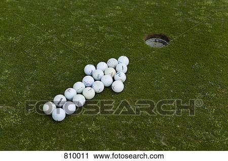 Arrow of golf balls pointing to a hole on a putting green View Large Photo Image Stock Image - Arrow of golf balls pointing to a hole on a putting green. Fotosearch