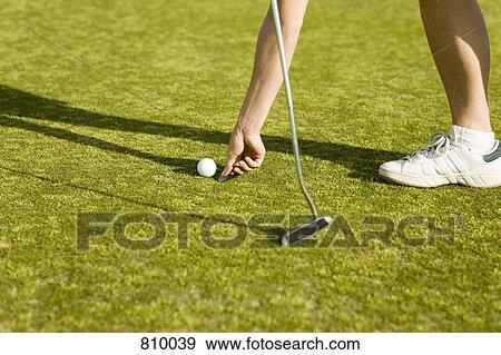 Detail of a golfer marking the ball's position with a coin View Large Photo Image Stock Photo - Detail of a golfer marking the ball's position with a coin. Fotosearch