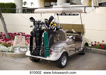 Stock Image - Golf cart in a parking lot. Fotosearch