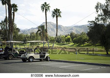 Stock Photograph - Golf carts parked at a golf club, Palm Springs, California, USA. Fotosearch