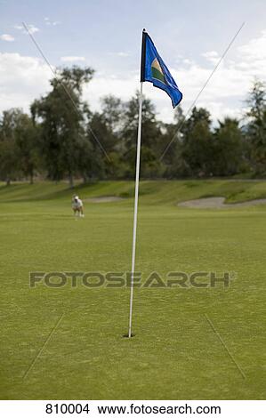 Golf flag on a putting green View Large Photo Image Picture - Golf flag on a putting green. Fotosearch