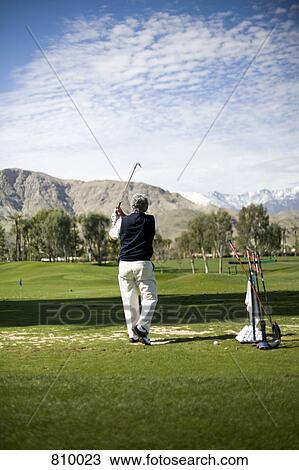 Rear view of a man playing golf, Palm Springs, California, USA View Large Photo Image Stock Image - Rear view of a man playing golf, Palm Springs, California, USA. Fotosearch