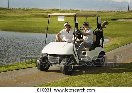 Two golfers in a golf cart View Large Photo Image Stock Image - Two golfers in a golf cart. Fotosearch