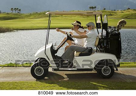 Two golfers in a golf cart View Large Photo Image Stock Photo - Two golfers in a golf cart. Fotosearch