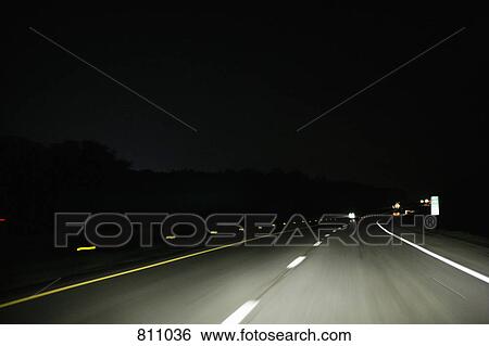 Stock Photograph - Multiple lane highway, night, non-urban scene. Fotosearch