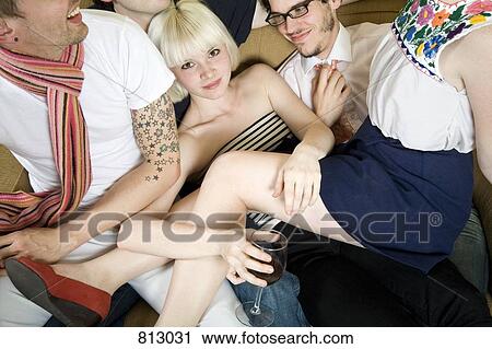 A group of friends piled on a sofa together View Large Photo Image Stock Image - A group of friends piled on a sofa together. Fotosearch