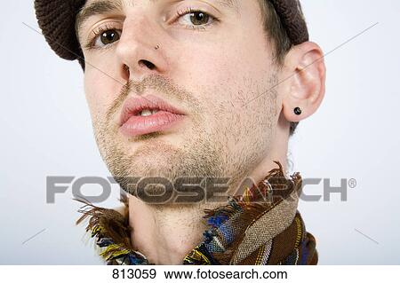 A portrait of a man wearing a hat and scarf View Large Photo Image Stock Photo - A portrait of a man wearing a hat and scarf. Fotosearch