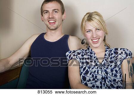 Stock Photography - A portrait of a young couple sitting together. Fotosearch