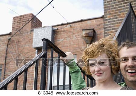 A young couple sitting on a stairway View Large Photo Image Stock Photography - A young couple sitting on a stairway. Fotosearch