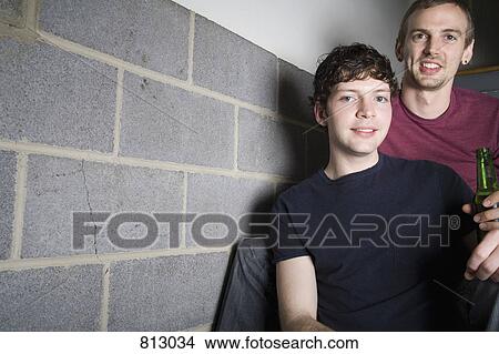 A young gay couple sitting in a stairway together View Large Photo Image Picture - A young gay couple sitting in a stairway together. Fotosearch