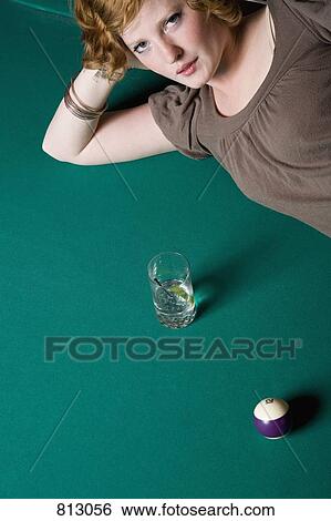 A young woman lying down on a pool table View Large Photo Image Stock Photograph - A young woman lying down on a pool table. Fotosearch