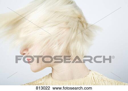 Stock Image - A young woman shaking her hair. Fotosearch