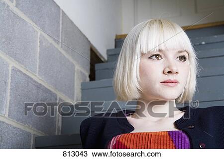 A young woman sitting on steps View Large Photo Image Stock Image - A young woman sitting on steps. Fotosearch