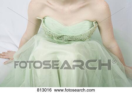 A young woman wearing a strapless vintage dress View Large Photo Image Stock Photograph - A young woman wearing a strapless vintage dress. Fotosearch
