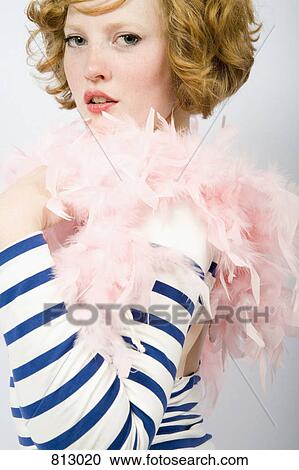A young woman wearing a striped sweater and a feather boa View Large Photo Image Stock Image - A young woman wearing a striped sweater and a feather boa. Fotosearch