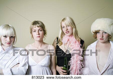 Four young women standing in a row View Large Photo Image Stock Image - Four young women standing in a row. Fotosearch